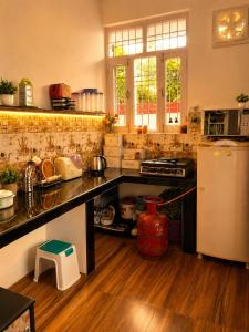 a kitchen with a counter top and a refrigerator at White View Park in Dharmsāla
