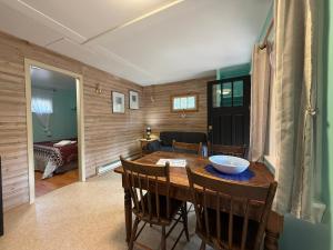 a kitchen and dining room with a table and chairs at Forest & Lake PEI Cottages in Murray Harbour