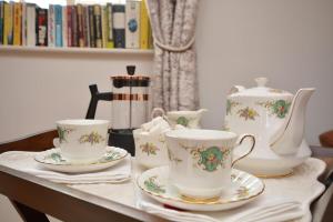 a table with three tea cups and saucers on it at 1 Bed in Gainsborough oc-66230 in Heapham