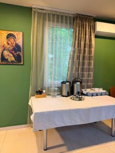 a table in a room with a window at Guest House Kekusic in Međugorje