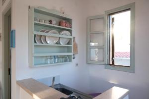 a kitchen with a sink and a window at Marietta Studios Patmos in Skala