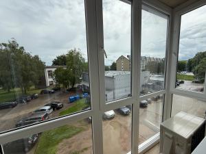 a view from a window of a parking lot at Greta Apartment in Alytus