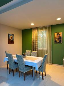 a dining room with a table and chairs at Guest House Kekusic in Međugorje