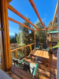 a view of a deck with a table and chairs at Cabaña de Mia in Villa Traful