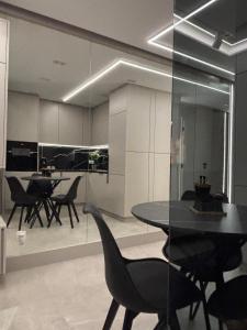 a dining room with a table and chairs at Apart CRYSTAL in Tomaszów Mazowiecki +18 photos