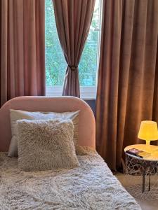 a bedroom with a bed and a window with curtains at Apart CRYSTAL in Tomaszów Mazowiecki
