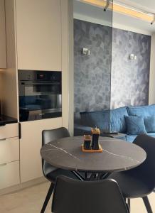 a kitchen and dining room with a table and chairs at Apart CRYSTAL in Tomaszów Mazowiecki
