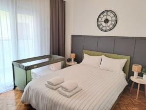 a bedroom with a bed with towels on it at Stylish City Center Apartment - with FREE PARKING space -not for big cars- 200m away in Serres