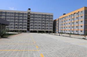 an empty parking lot in front of a large building at Liaden 2 Bedroom Apartment in Nairobi