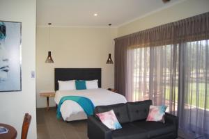 A bed or beds in a room at Manzanillo Grove Villa