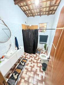 a bathroom with a toilet and a sink at Sítio Sombra da Figueira in Paty do Alferes +29 photos