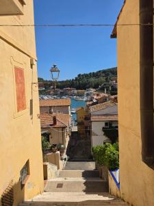 an alley between two buildings with a view of a river at SnowWhite Home in Porto Ercole