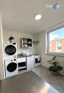 a kitchen with white appliances and a window at BEGE APARTMENTS WorkPoint in Dorsten
