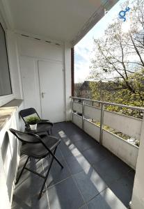 a balcony with a chair and a window at BEGE APARTMENTS WorkPoint in Dorsten