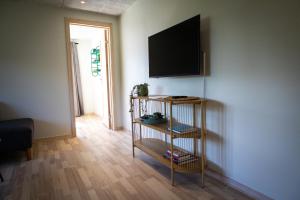 a living room with a flat screen tv on a wall at Billund Guest Lodge 2 in Hejnsvig