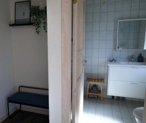 a bathroom with a toilet and a sink and a door at Billund Guest Lodge 2 in Hejnsvig +18 photos