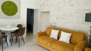 a living room with a couch and a table at Montesanto 60 Suite & Relax Alberobello in Alberobello