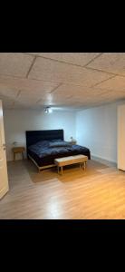 a bedroom with a bed and a coffee table at Hørballegård in Skanderborg