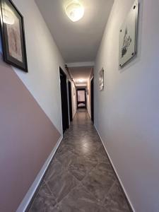 an empty hallway with a long hallway with white walls at Sobe Mračević in Sutorina