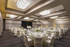 a banquet hall with white tables and chairs at The Satire, Autograph Collection in Alexandria