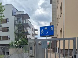 a blue street sign in front of some buildings at Radiowa mini in Warsaw