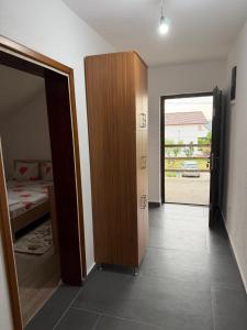 a room with a door to a bedroom with a bed at Airport Studio apartman ravna gora in Mitrovići