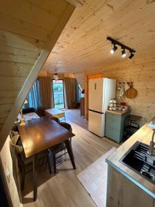 a kitchen and dining room with a table in a cabin at Chalet Marta in Kobuleti