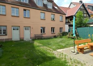 a house with a green yard in front of it at Fewo Backboard in Röbel +3 photos