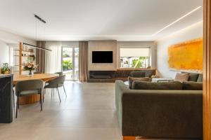a living room with a couch and a table at Aeliah in Anavyssos