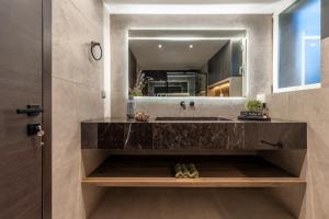 a bathroom with a sink and a mirror at Aeliah in Anavyssos +32 photos