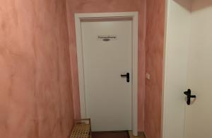 a white door with a sign on it in a room at Fewo Steuerboard in Röbel