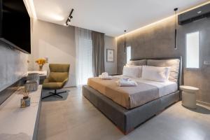 a bedroom with a large bed and a chair at Aeliah in Anavyssos
