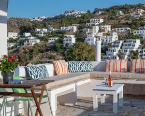 a bench on a patio with a view of a city at Marietta Studios Patmos in Skala