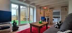 a living room with a couch and a table at La petite maison d'Hose in Monistrol-sur-Loire