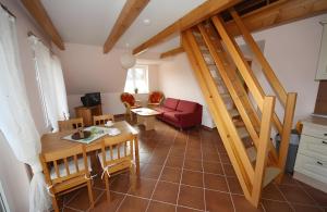 a living room with a red couch and a staircase at Haus u8 in Röbel