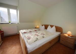 a bedroom with a bed with a wooden frame at Haus u8 in Röbel
