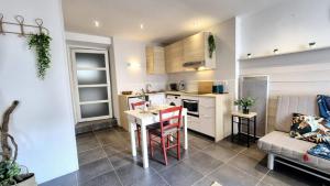 a small kitchen with a table and a couch at Garaztegia Studio in Ustaritz +9 photos