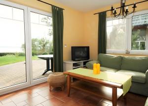 a living room with a couch and a tv at Haus 12 in Röbel