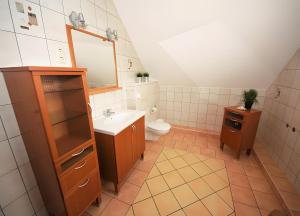 a bathroom with a sink and a toilet at Haus 12 in Röbel +11 photos