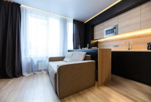 a kitchen with a couch and a sink in a room at Fayna Town Comfort #2 in Kyiv +25 photos