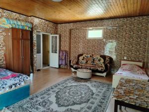 a living room with a couch and a table at good house in Quba