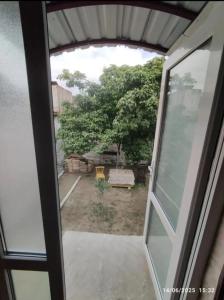a view from a glass door of a yard at good house in Quba