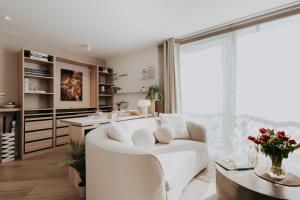 a living room with a white couch and a table at Saturn Studio by Navie Stays in Poole