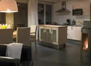 a kitchen with a table and a kitchen with a fireplace at Haus W 7 in Röbel
