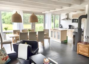 a living room with a kitchen and a dining room at Haus W 7 in Röbel