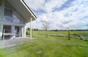 a white house with a deck and a yard at Haus W 7 in Röbel