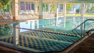 an empty swimming pool with chairs in a building at Ihre exklusive Auszeit im Allgäu in Scheidegg