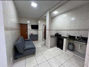 a large bathroom with a chair and a sink at Executivo Central 102 in Ipatinga