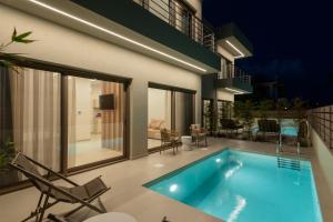 a swimming pool in the middle of a house at IONE Suites in Preveza