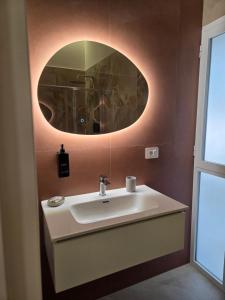 a bathroom with a sink and a mirror at Suite in centro in Aversa